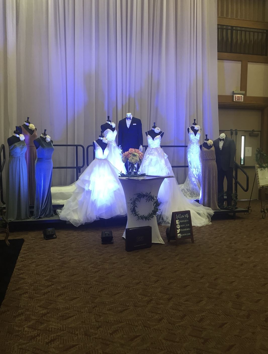 Photo of the bridal gowns and tuxedo with a bouquet